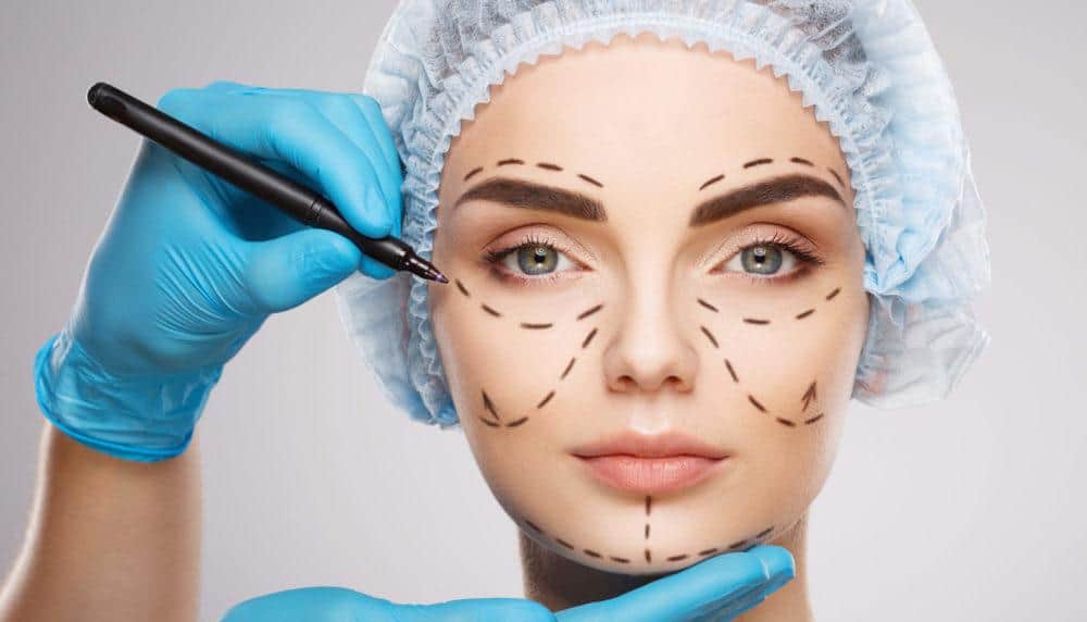 Drawing Lines on a Woman's Face - Plastic Surgergy