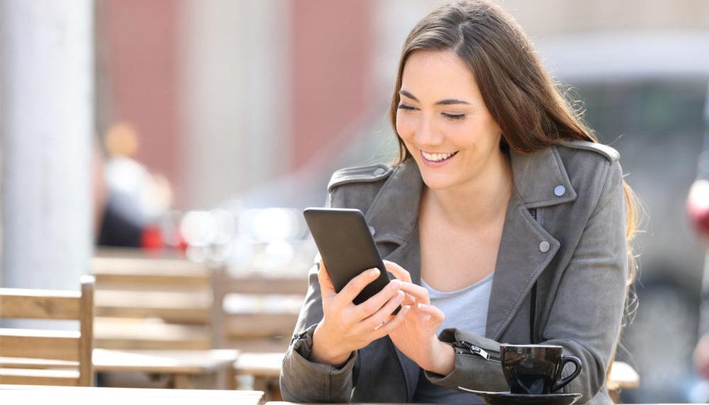 a woman is sitting at a table with a cup of coffee