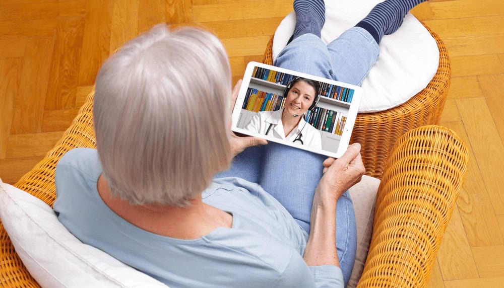 A Person Sitting in a Chair While on a Telehealth Call