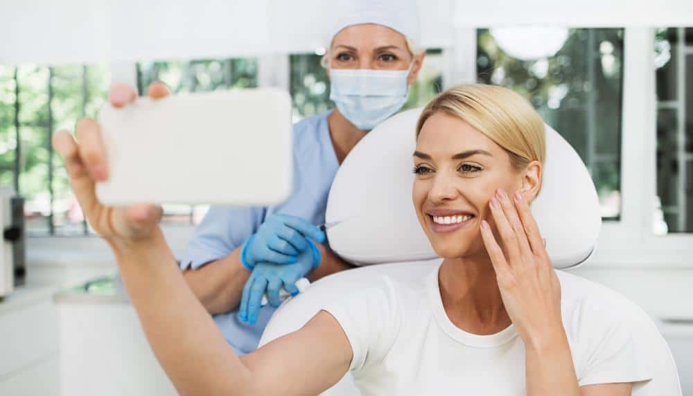 A woman using her phone camera at a medical clinic