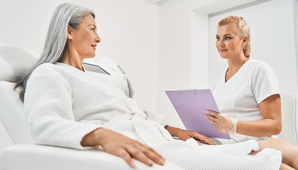 a nurse talking to a patient at an IV clinic