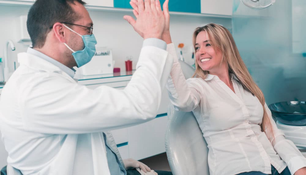 A Male Dentist Gives a Woman a High Five